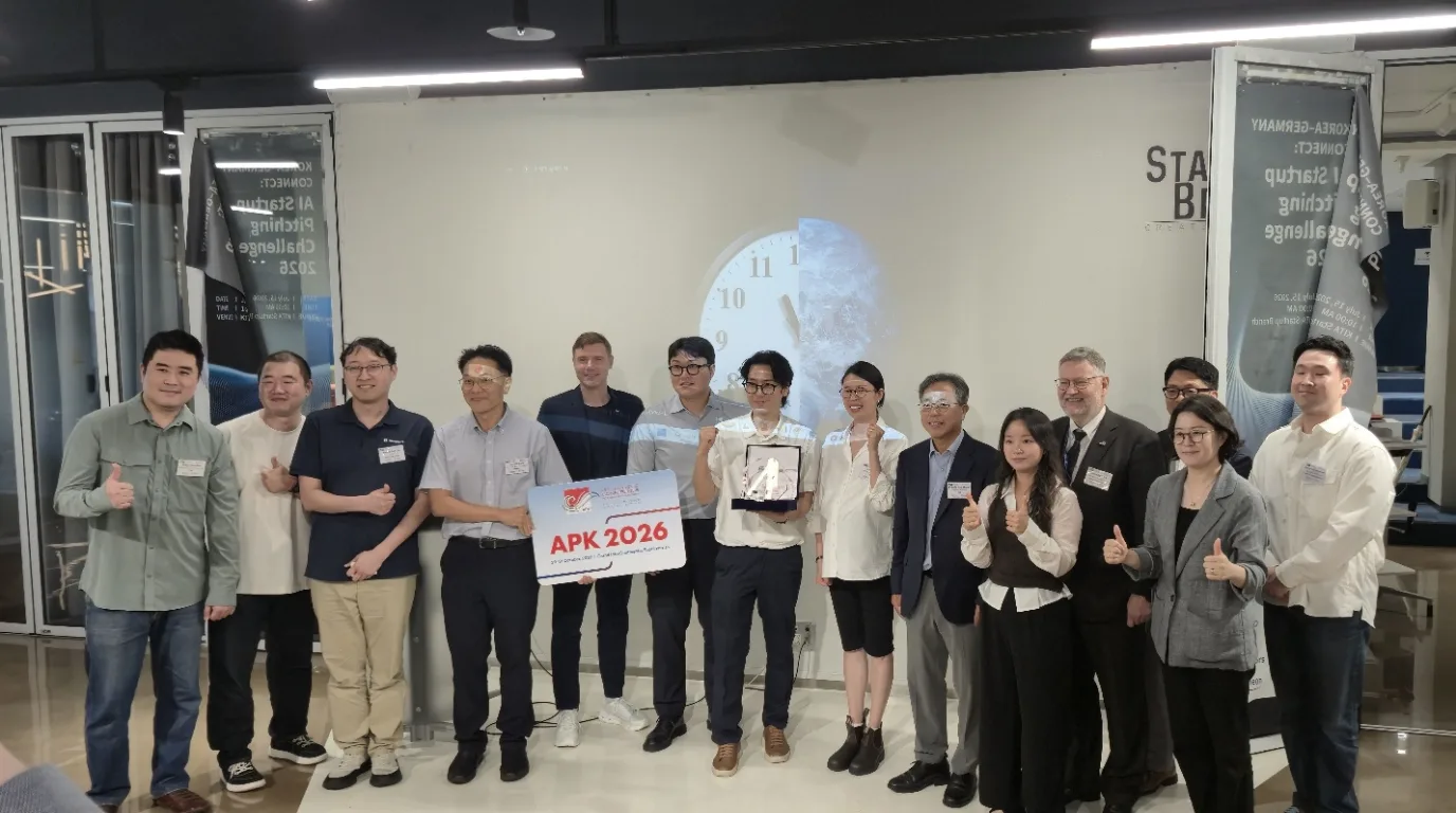 The five finalist teams and the jury on stage at KITA Startup Branch, holding an APK 2026 sign and the winner’s trophy